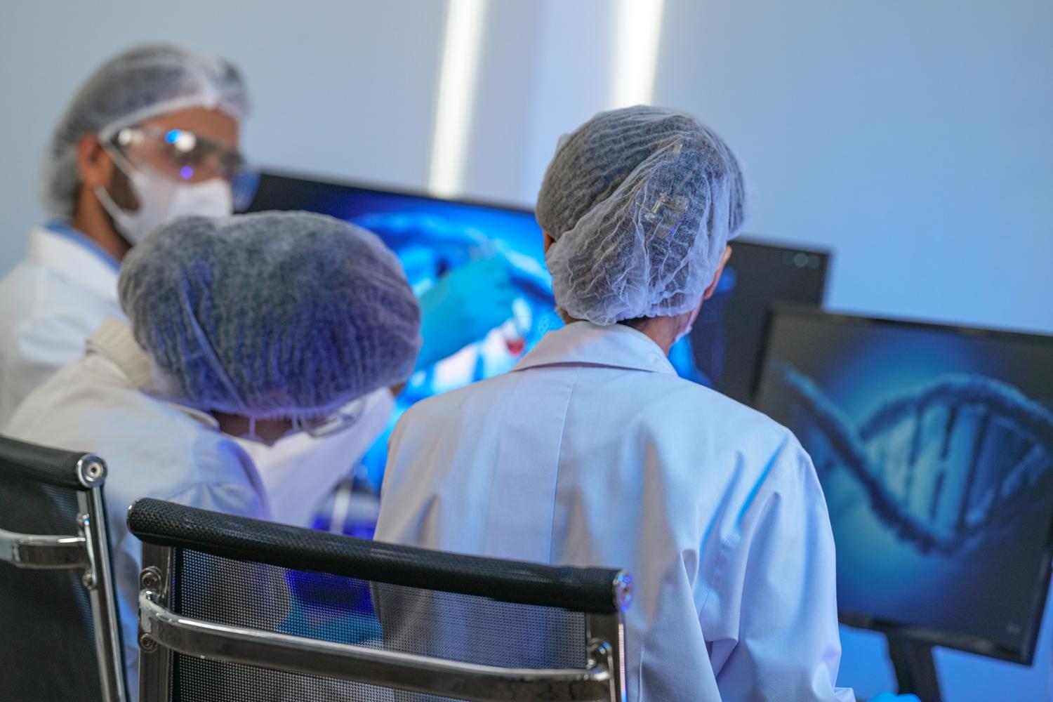 Scientists analyzing DNA on monitors