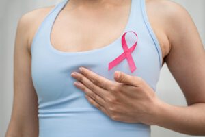 Woman with pink ribbon on chest