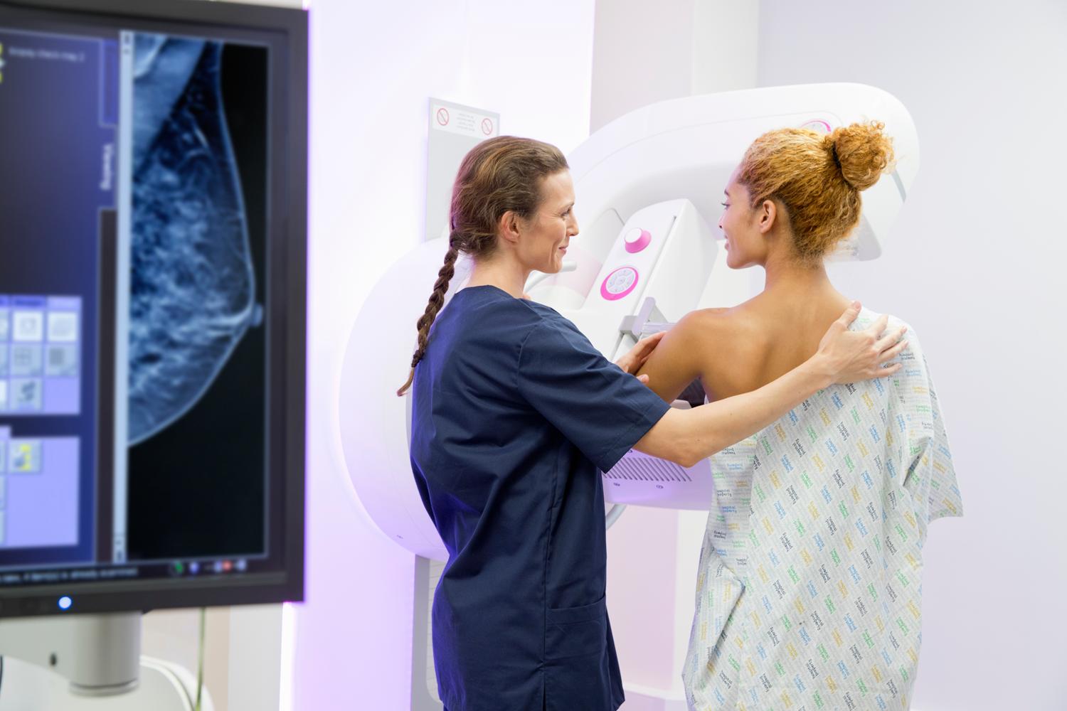 Medical professionals performing a mammogram.