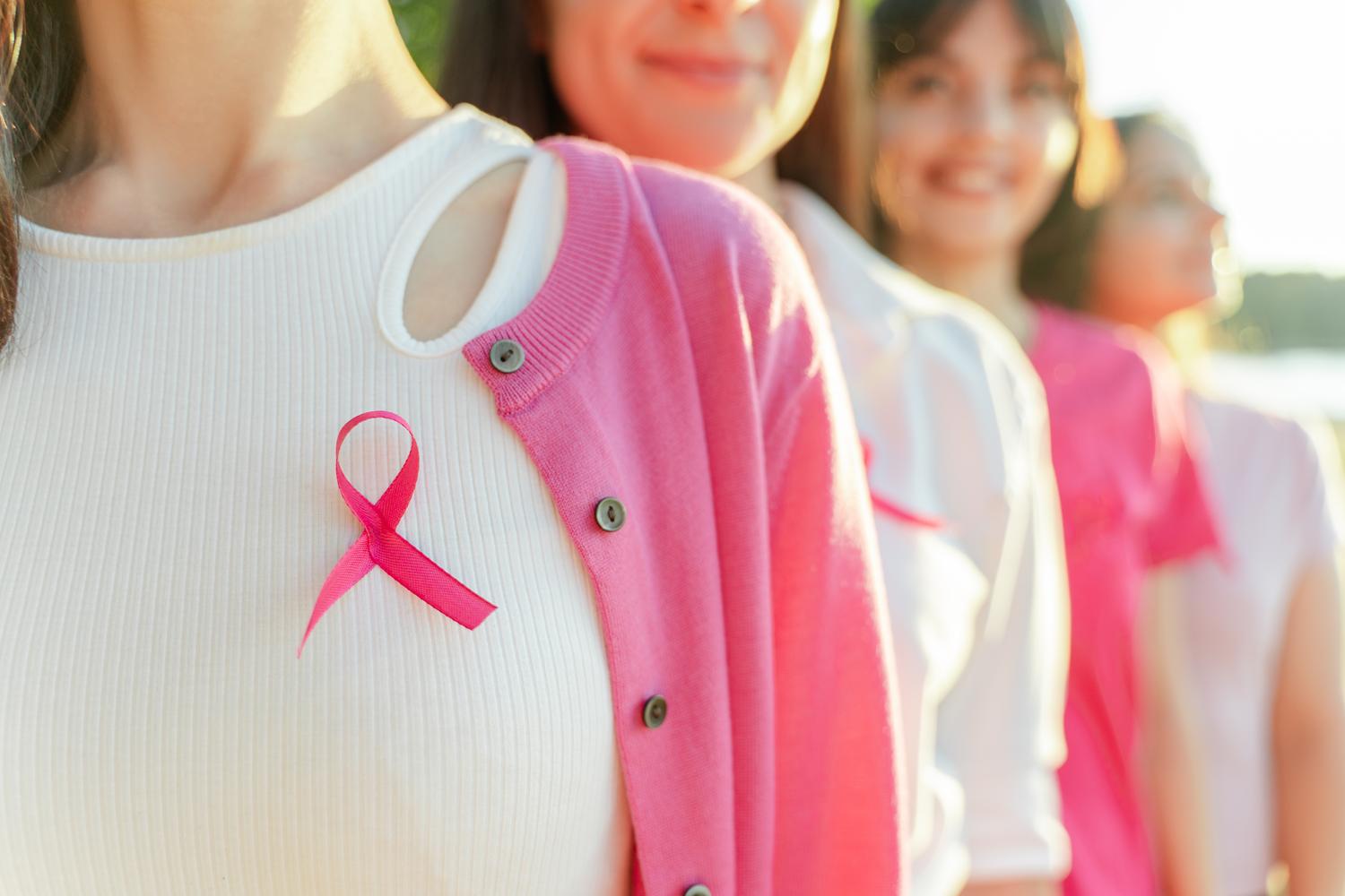 Women wearing pink ribbons for awareness